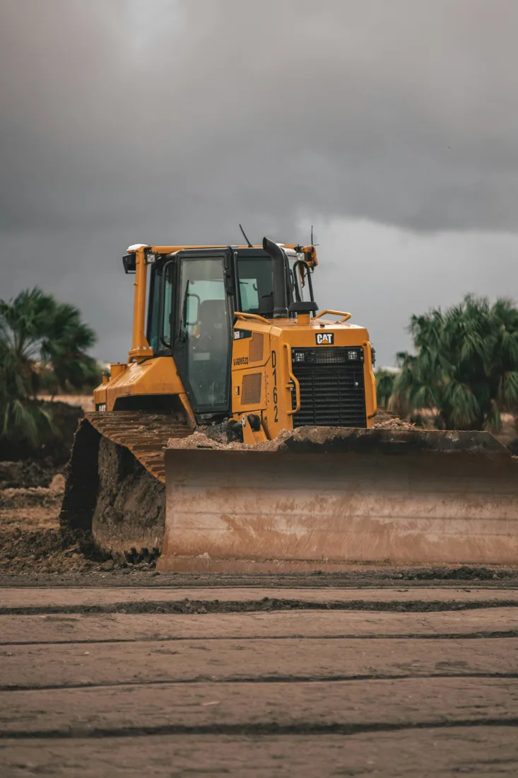 Bulldozer shaping a broad dirt surface