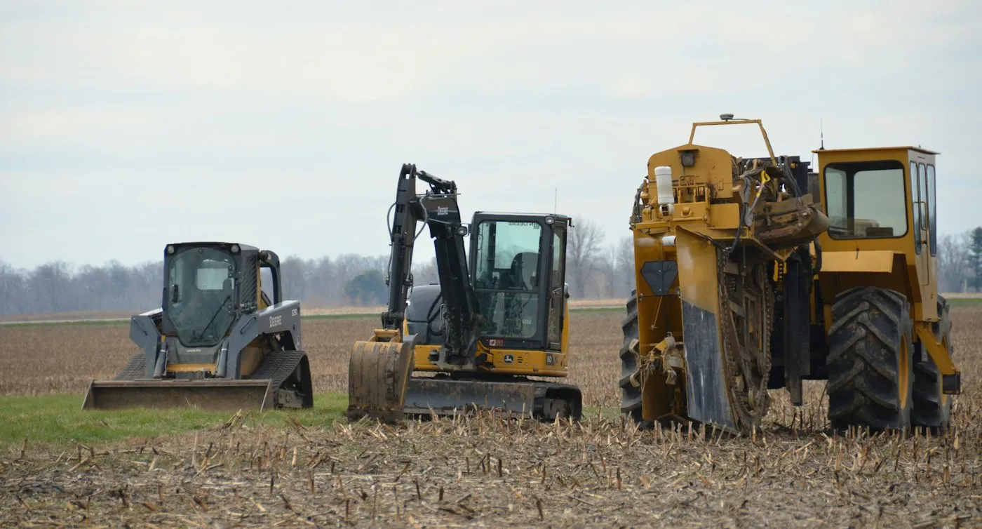 Compact excavators standing on an open field